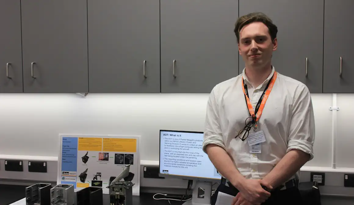 A student stands in front of his project at Engineering Day.