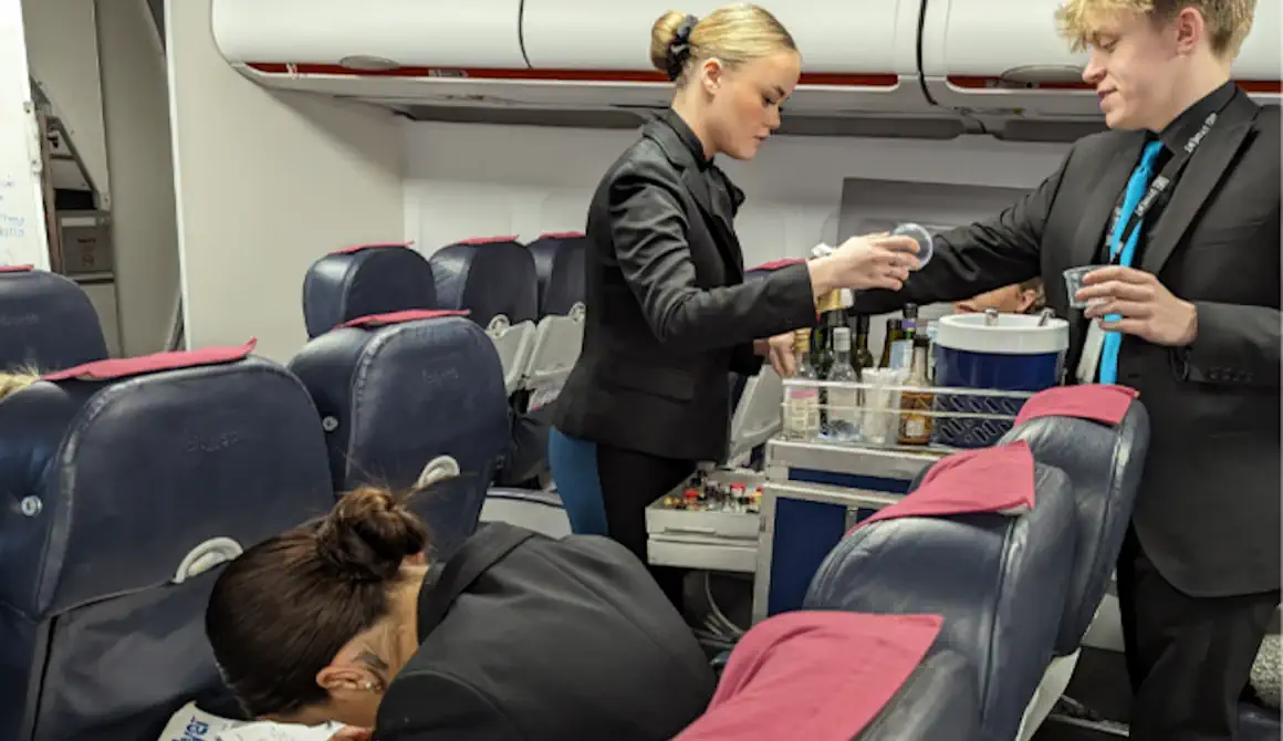 Students handing out refreshments on a flight.