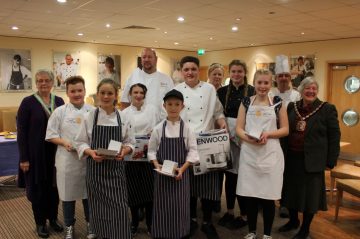 catering students and chefs standing, posing for a picture in their chef uniforms
