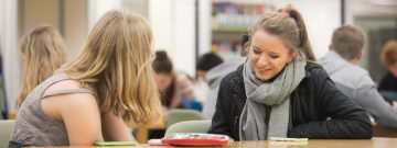 students sitting in a social space chatting