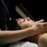 a woman getting a beauty treatment by one of our students in the synergy salon