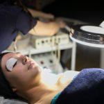 a woman getting a beauty treatment by one of our students in the synergy salon