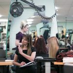 a lecturer advising a student in synergy salon