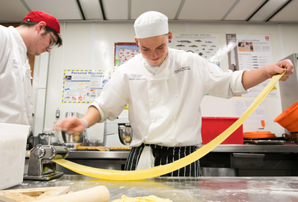 catering students hand making pasta