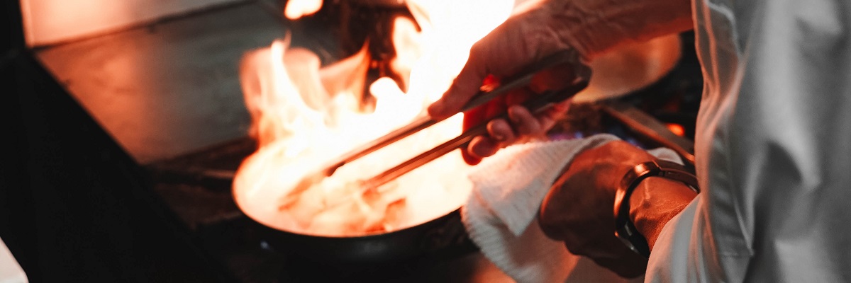 closeup of a chef cooking with fire