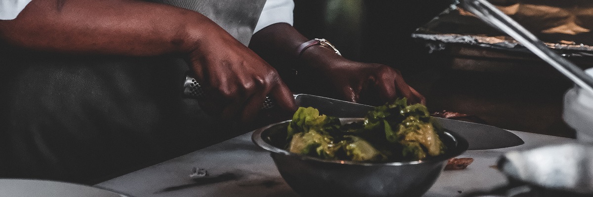 closeup of a chef preparing food in a kitchen