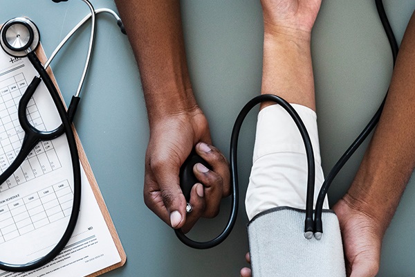 a person taking someones blood pressure