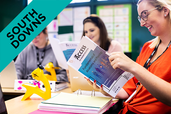 HSDC students in an access class holding a work book