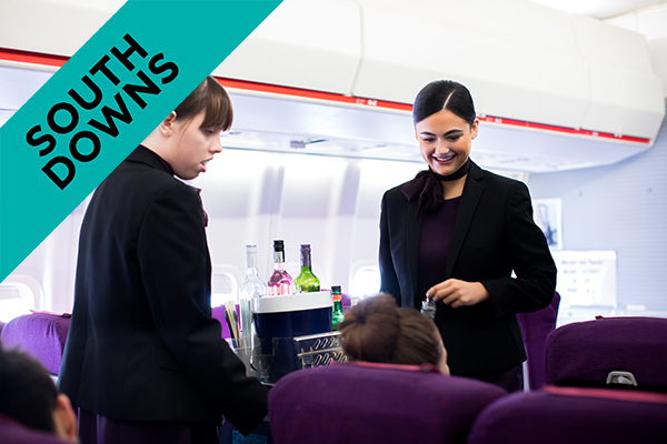air cabin crew carrying beverages in a plane
