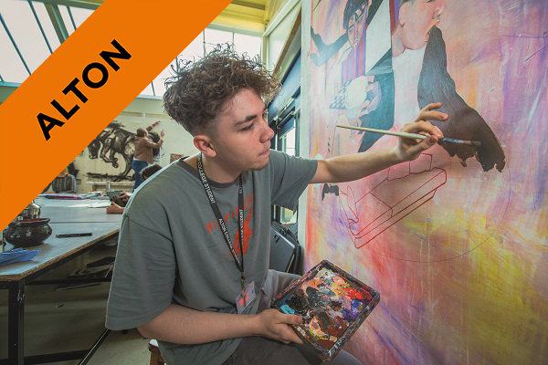 A Level Art and Design student painting a wall