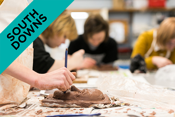 a student working on a clay sculpture