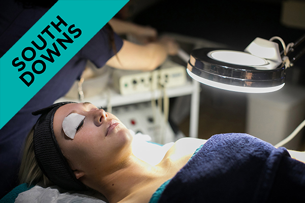 a beauty student giving a woman a facial