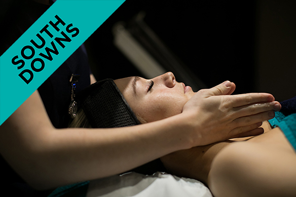 a beauty student giving a woman a facial