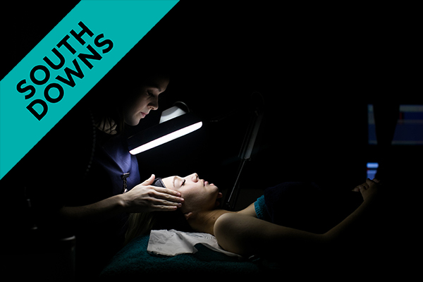 a beauty student giving a woman a facial