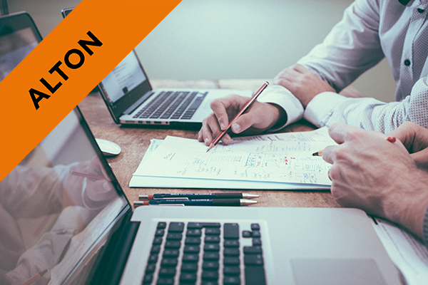 two people having a meeting with laptops and notebooks