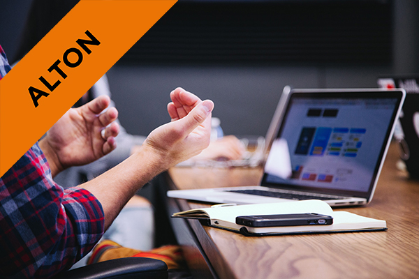 a person speaking whilst sat in front of a laptop