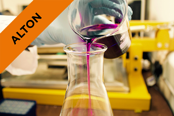 chemicals being poured into a beaker