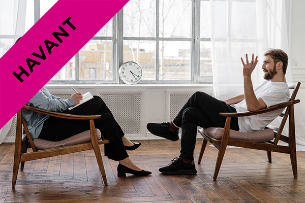 two people sat opposite each other in a counselling session