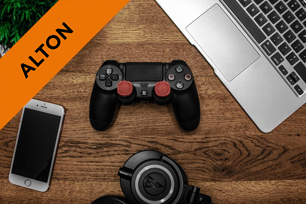 a ps4 controller, headphones, laptop and iphone on a desk