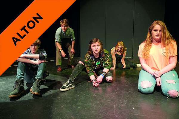 drama students posing on stage