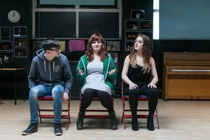 three students in drama class