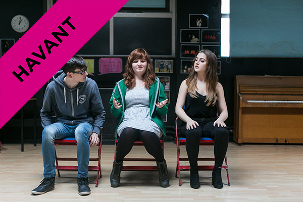 A Level Drama and Theatre Studies students sitting on chairs in a drama studio