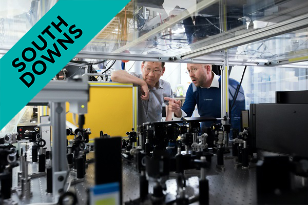 two males looking at machinery