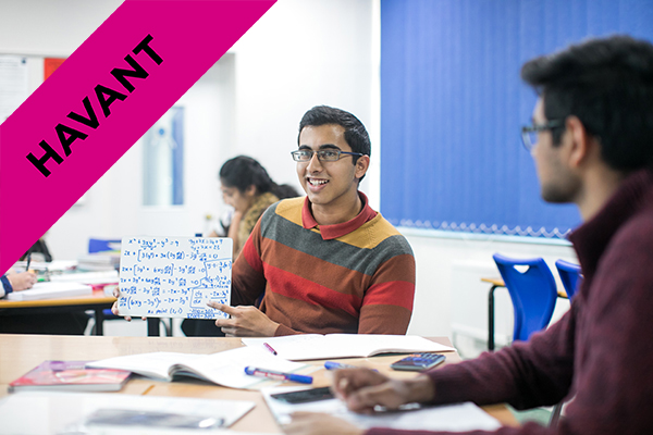a student holding up math equations in class