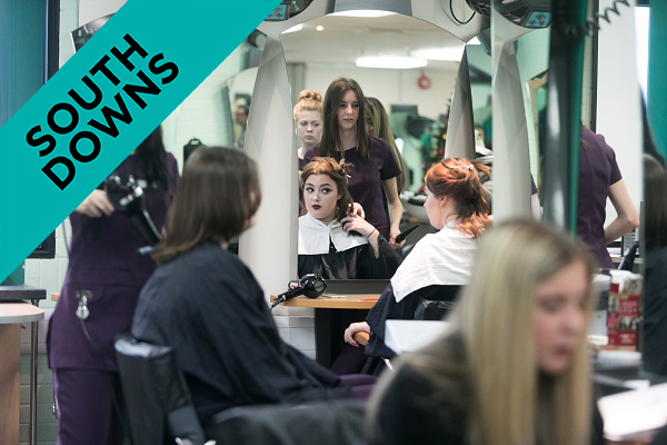 students in the college salon working on client's hair