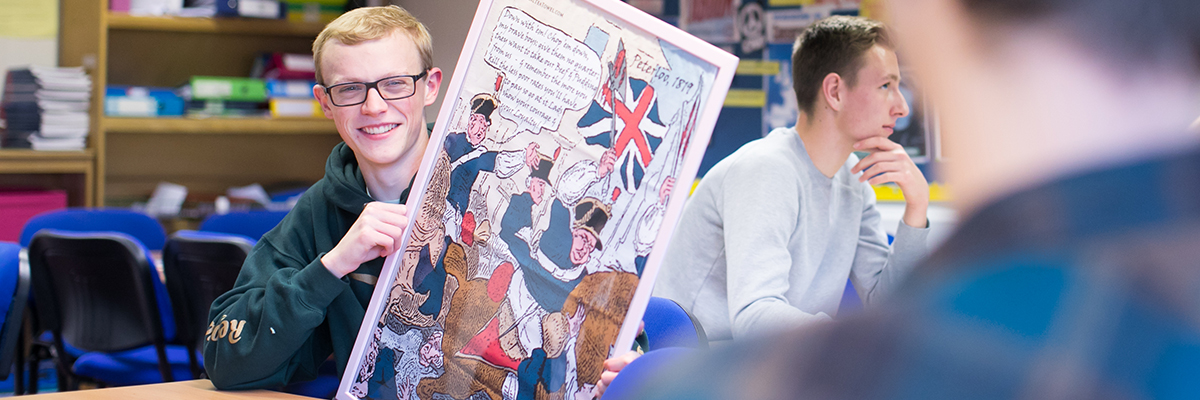 student holding up a historical poster