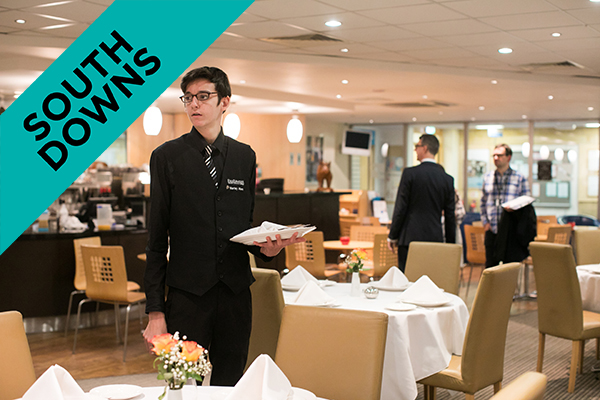 a student serving in the college restaurant