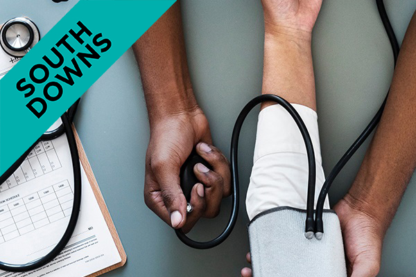 a person taking someones blood pressure