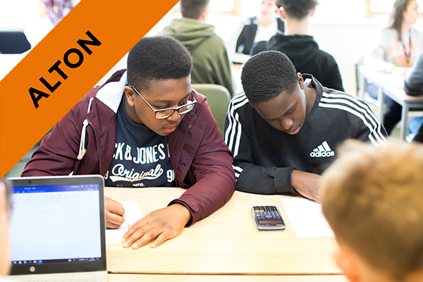 two students working together at a desk