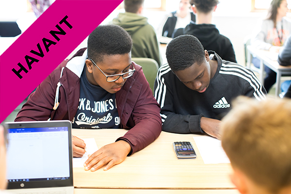 two students working together with a calculator