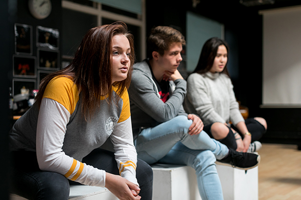 three students listening