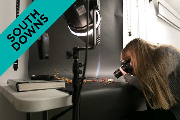 a student taking a photo in a photography studio