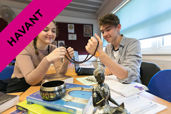 two students holding a religious artefact