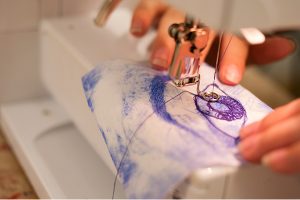 someone using a sewing machine