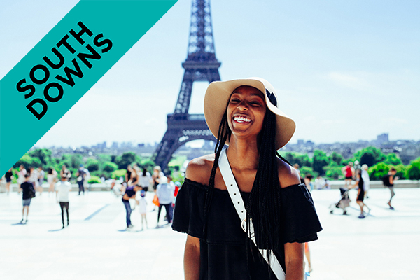 a woman standing in front of the Eiffel tower