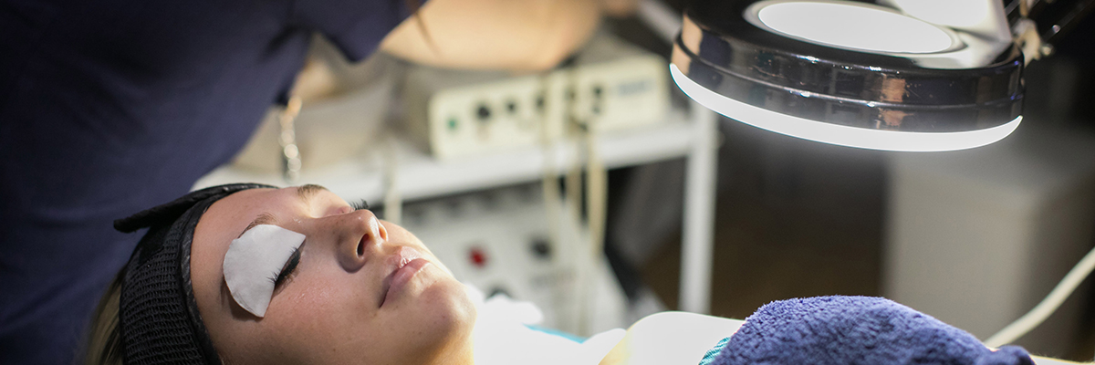 a beauty student giving a woman a facial