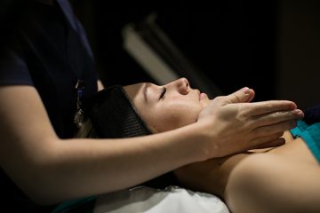 a beauty student giving a woman a facial