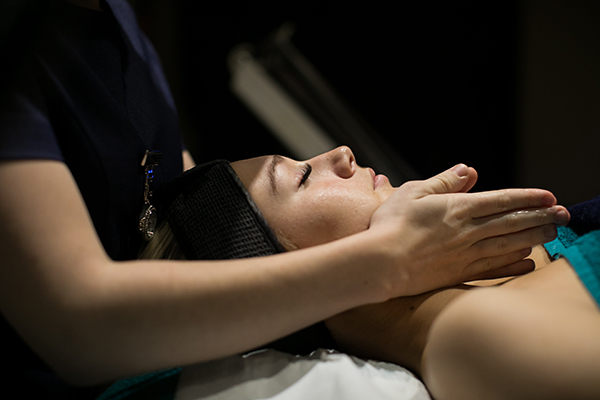 a beauty student giving a woman a facial