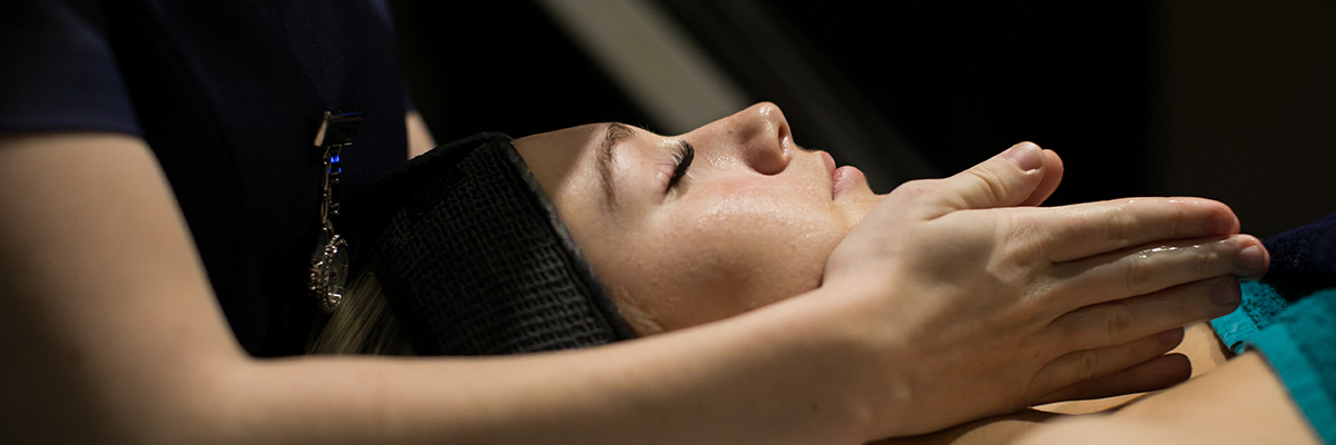 a beauty student giving a woman a facial
