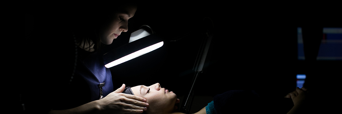 a beauty student giving a woman a facial