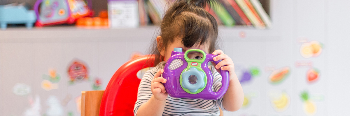 a child playing with a toy camera