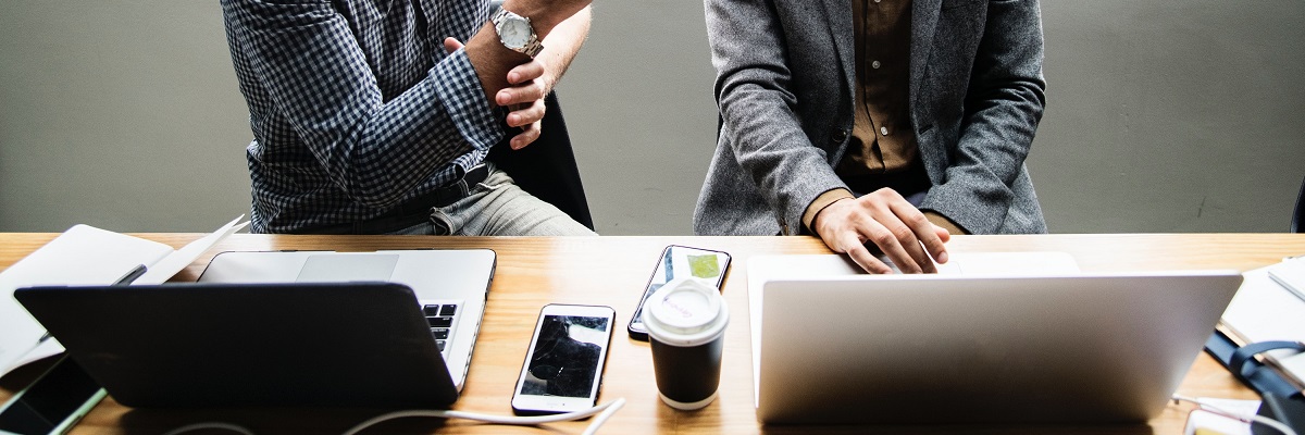 two people on laptops