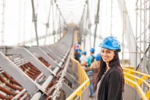 a woman wearing a hard hat on a structure