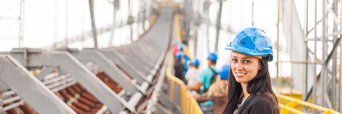 a woman wearing a hard hat on a structure