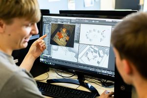 two people looking at designs on a computer screen