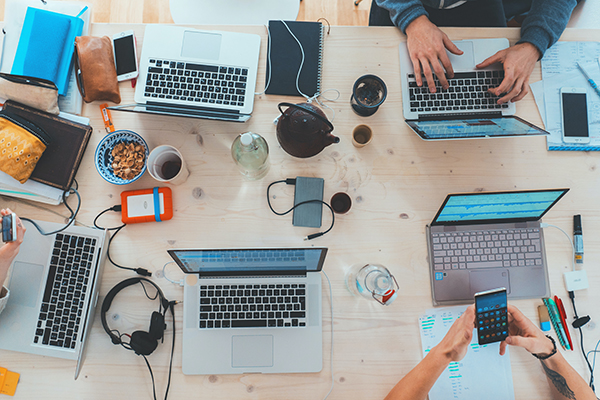aerial view of a desk with laptops